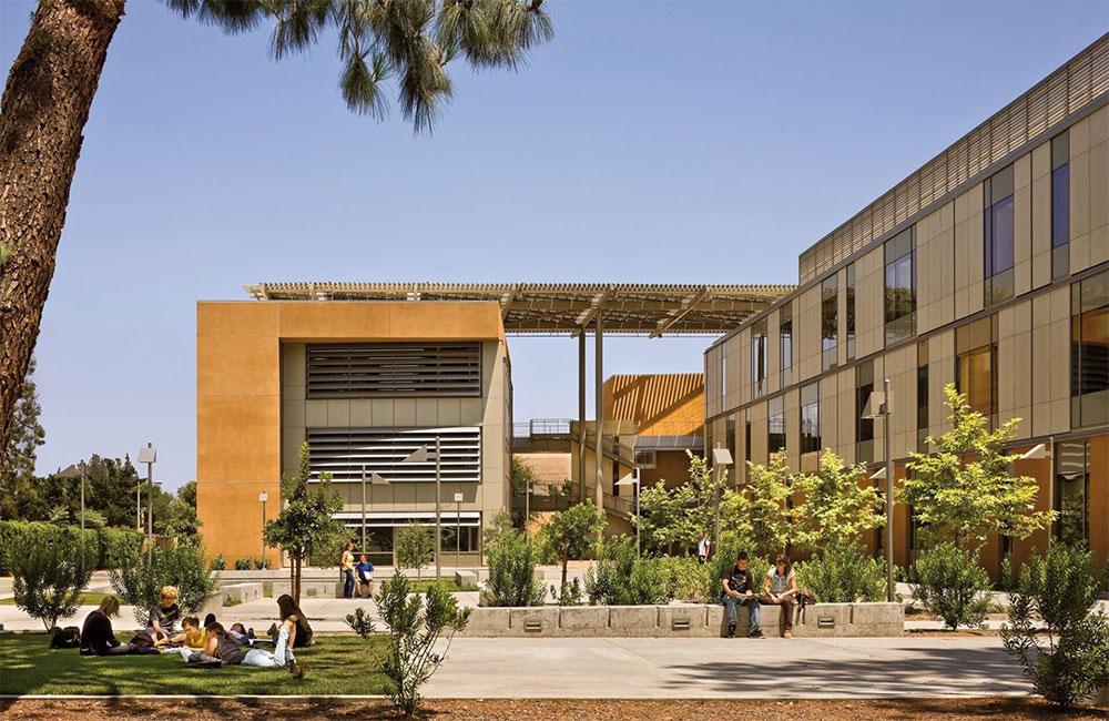 Image 6. A 3-story modern building with a minimalist plaza in the foreground.