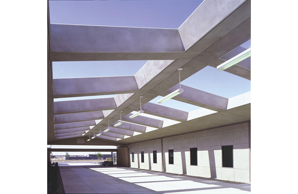 Image 4. Outdoor walkway with beams above supporting suspended linear light fixtures.