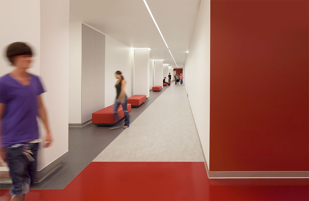 Image 6. Interior corridor featuring a modern red and white color scheme.