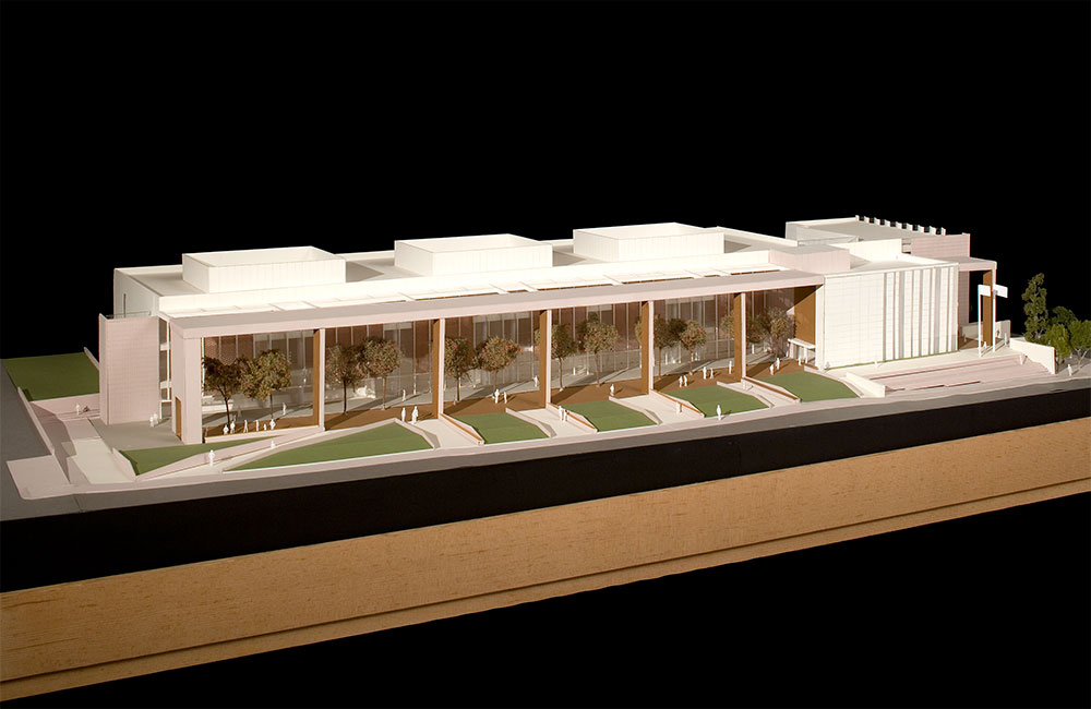 Image 6. Model of courthouse showing a row of wood paneled columns located in front of the glass curtain wall facade of courthouse building.