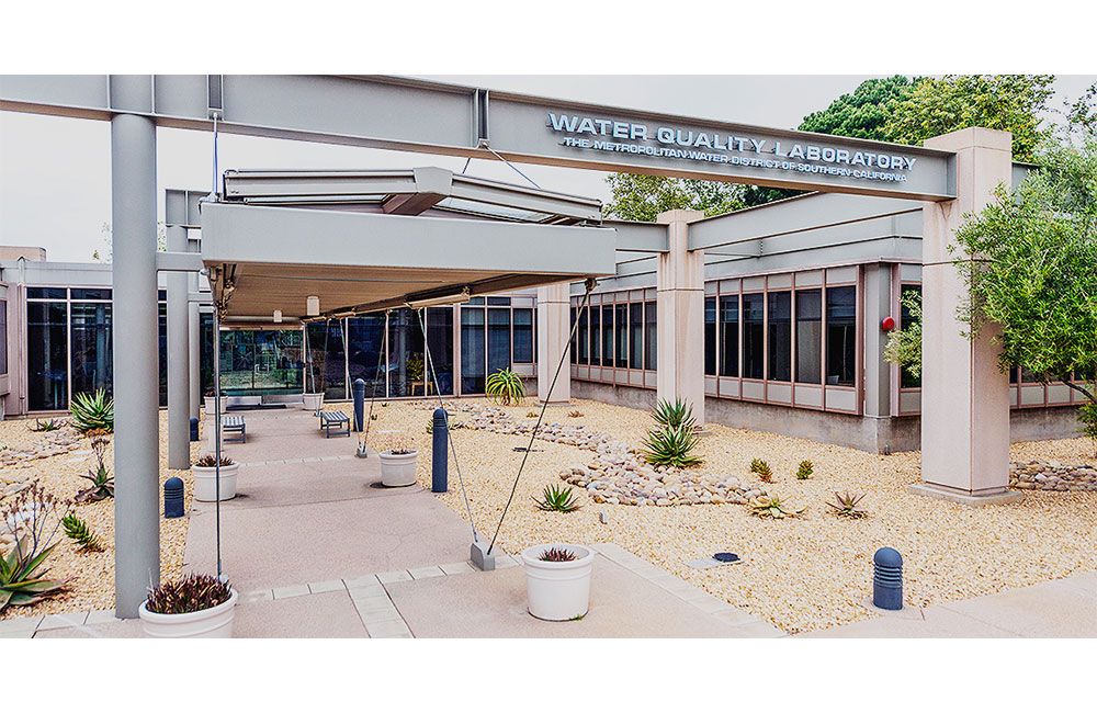 Image 6. Main entry to building with steel columns supporting beams and canopy structure above.